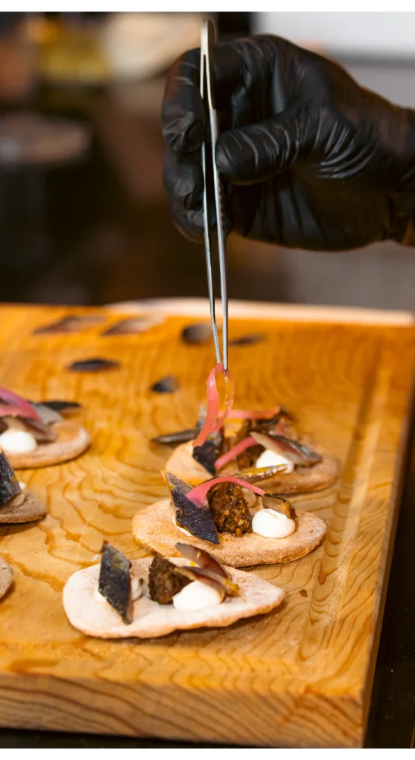 Precision food preparation with tweezer by private Chef CDMX